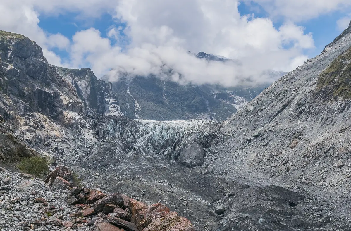 The ice of Fox Glacier between steep valley walls