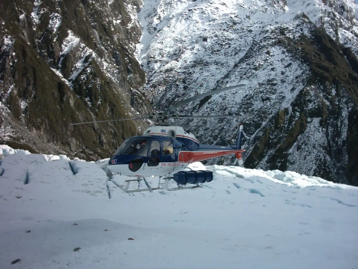A helicopter on a snow landing high on the glacier névé